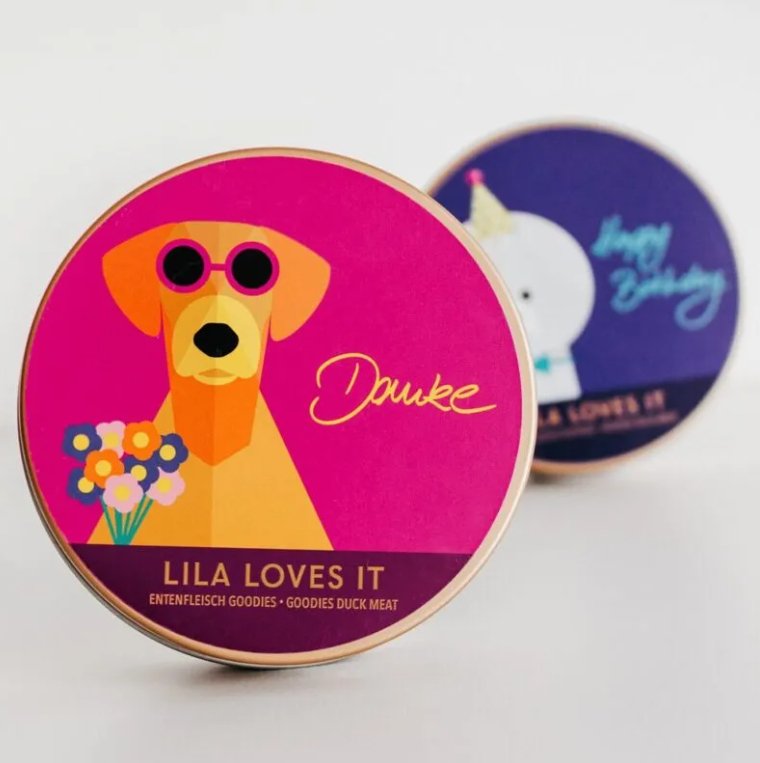 Colorful pet treat cans from LILA LOVES IT featuring a stylish dog and festive designs for special occasions.