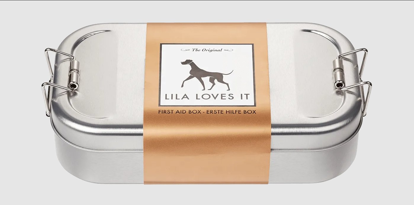 Metal first aid box for dogs, labeled 'Lila Loves It', essential for pet injury care.