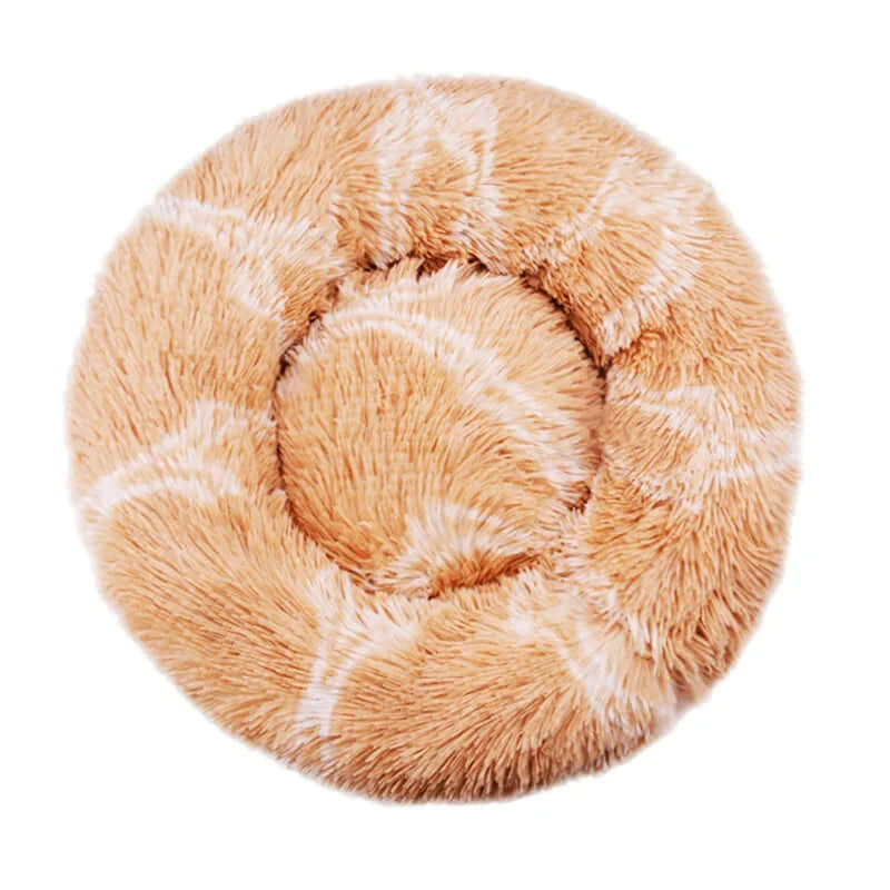 Soft round pet bed in beige plush material, ideal for dogs and cats for warm and cozy sleeping.